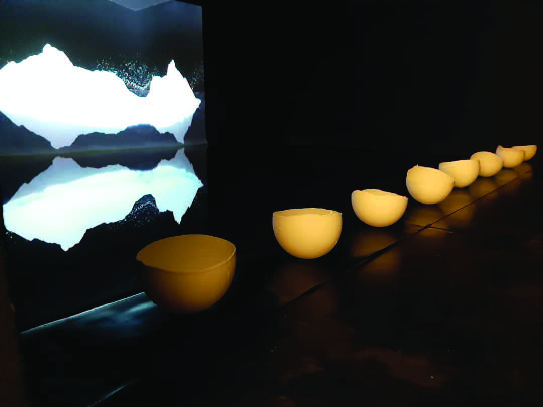 Mateja Šmic, Deconstruction of a mountain / Equilibrium, video installation: 300 x 400 cm basin of Turkish coffee, Video projection, plaster pieces (2019), image courtesy of the artist.